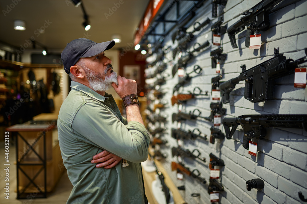 A customer studying the rifle wall